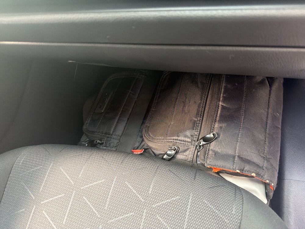 Passenger seat slid all the way forward over the backpack.